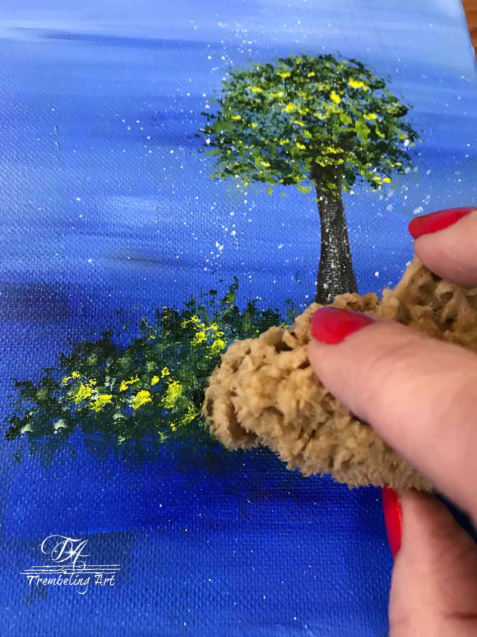 using a sponge technique to paint trees and bushes