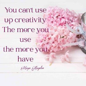 Background with white candle and pink hyacinths flowers on white wooden planks with creativity quote