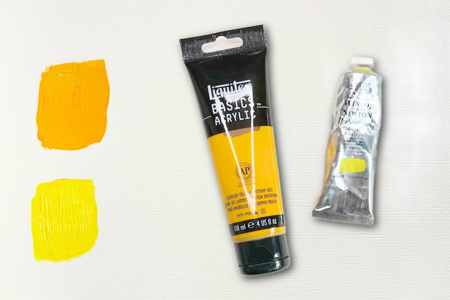 Two swatches of yellow paint and two tubes of yellow paint, Cadmium yellow medium and Lemon yellow.